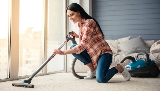 Lady cleaning carpet floor | Family Flooring