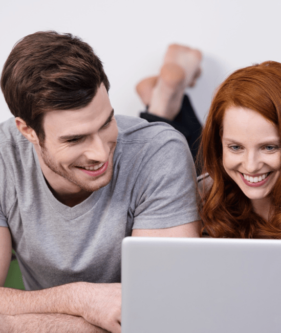 Happy couple with laptop | Family Flooring